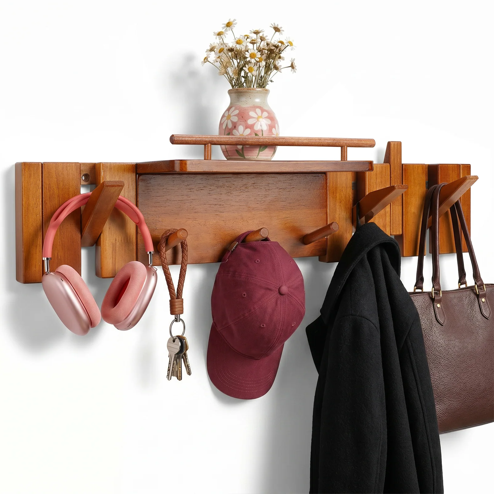 Wall-mounted hanger holding daily accessories beneath a display shelf